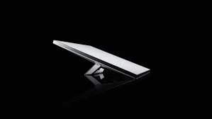 Starlink Mini dish on its kickstand against a black background